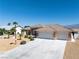 Beautiful home featuring a three-car garage, desert landscaping, and proximity to scenic mountain views at 5450 Grain Mill Rd, Pahrump, NV 89061