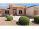 Welcoming home entrance featuring desert landscaping, a stylish front door, and decorative exterior lighting at 5450 Grain Mill Rd, Pahrump, NV 89061
