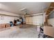 Spacious garage with overhead door, shelving, and ample room for storage at 5450 Grain Mill Rd, Pahrump, NV 89061