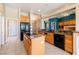 Spacious kitchen featuring wood cabinets, tile floors and a kitchen island with range at 5450 Grain Mill Rd, Pahrump, NV 89061