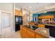 Lovely kitchen with light-colored cabinets, dark granite countertops, tile floors and black appliances at 5450 Grain Mill Rd, Pahrump, NV 89061