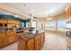 Open concept kitchen features granite countertops, a kitchen island, and views of the mountains at 5450 Grain Mill Rd, Pahrump, NV 89061