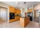 Well-lit kitchen with wooden cabinets, tile floor, granite counters, and stainless steel appliances at 5450 Grain Mill Rd, Pahrump, NV 89061