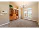 Cozy living room with plush carpet, bright window and built-in cabinets with decorative trim at 5450 Grain Mill Rd, Pahrump, NV 89061