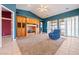 Spacious living room with vaulted ceilings, built-in shelving, and sliding glass doors to the outside patio at 5450 Grain Mill Rd, Pahrump, NV 89061