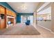 Open living room with views of the backyard, carpeted section, and opening to kitchen area at 5450 Grain Mill Rd, Pahrump, NV 89061