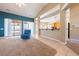 Bright living room with tile floors, views of the backyard, and open access to the kitchen at 5450 Grain Mill Rd, Pahrump, NV 89061