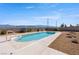 Enjoy this stunning backyard pool surrounded by desert landscaping and mountain views at 5450 Grain Mill Rd, Pahrump, NV 89061
