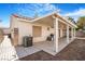 Wide shot of a backyard with a covered patio, hardscape and rock landscaping at 5544 Cloudy Glen St, North Las Vegas, NV 89031