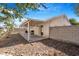 Wide shot of a backyard with a covered patio, hardscape and rock landscaping at 5544 Cloudy Glen St, North Las Vegas, NV 89031