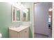 Bathroom featuring a single sink vanity with a stylish mirror and modern fixtures at 5544 Cloudy Glen St, North Las Vegas, NV 89031