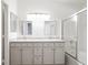 Bright bathroom with double sinks, a shower and tub, and lots of cabinet storage at 5544 Cloudy Glen St, North Las Vegas, NV 89031