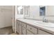 Bathroom featuring double sinks, light countertops, and a walk in closet at 5544 Cloudy Glen St, North Las Vegas, NV 89031