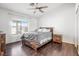 Charming bedroom featuring a wooden bed frame, ceiling fan, and bright natural light at 5544 Cloudy Glen St, North Las Vegas, NV 89031