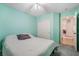 Cozy bedroom featuring light aqua walls, a ceiling fan, and carpet at 5544 Cloudy Glen St, North Las Vegas, NV 89031