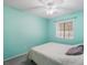Bedroom with light aqua walls, a ceiling fan, and a plush bedspread at 5544 Cloudy Glen St, North Las Vegas, NV 89031