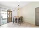 Cozy dining area with tile floor and a sliding glass door to the backyard at 5544 Cloudy Glen St, North Las Vegas, NV 89031