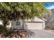 Charming single-story home featuring an attached two-car garage, window and mature landscaping at 5544 Cloudy Glen St, North Las Vegas, NV 89031