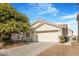 Charming single-story home featuring an attached two-car garage and nice landscaping at 5544 Cloudy Glen St, North Las Vegas, NV 89031