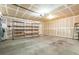 Spacious garage with ample storage shelves and a concrete floor at 5544 Cloudy Glen St, North Las Vegas, NV 89031