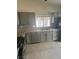 Bright kitchen featuring gray cabinets, stainless steel appliances, and tile backsplash at 5544 Cloudy Glen St, North Las Vegas, NV 89031
