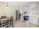 Kitchen featuring gray cabinets, stainless steel appliances, tile floors and a dining table at 5544 Cloudy Glen St, North Las Vegas, NV 89031