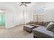 Bright living room featuring a neutral color palette, tiled flooring, and a comfortable sectional sofa at 5544 Cloudy Glen St, North Las Vegas, NV 89031