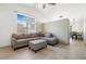 Open-concept living room featuring tile floors, a large window and a comfortable sectional sofa at 5544 Cloudy Glen St, North Las Vegas, NV 89031