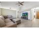 Spacious living room with tile floors, a large sectional sofa, and a wall-mounted television at 5544 Cloudy Glen St, North Las Vegas, NV 89031