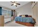 Cozy bedroom with sloped ceilings, a ceiling fan, a bed with drawers, and ample natural light at 5884 Deer Valley Dr, Las Vegas, NV 89156