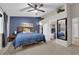 Spacious main bedroom featuring a ceiling fan, a large bed, and an en-suite bathroom at 5884 Deer Valley Dr, Las Vegas, NV 89156
