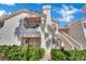 Exterior shot of the apartment complex displaying its multiple floors, balconies, and charming architectural style at 605 Devonhall St # 202, Las Vegas, NV 89145