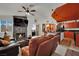 Inviting living room featuring a fireplace, comfortable leather seating, and an open view to the kitchen at 605 Devonhall St # 202, Las Vegas, NV 89145