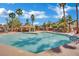 Large community pool and poolside cabana offer a refreshing oasis lined with palm trees and lounge chairs at 605 Devonhall St # 202, Las Vegas, NV 89145
