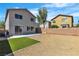 A large backyard with desert landscaping, small lawn, and a patio at 6282 Dollar Bill Ct, Las Vegas, NV 89141