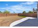 A large backyard has desert landscaping, a small lawn, and a concrete patio at 6282 Dollar Bill Ct, Las Vegas, NV 89141