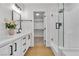 Bathroom with dual sinks, vanity, and shower with a glass door at 6282 Dollar Bill Ct, Las Vegas, NV 89141