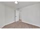 Clean bedroom showcasing neutral carpet and white walls, leading to another room through a doorway at 6282 Dollar Bill Ct, Las Vegas, NV 89141