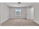 Bright, spacious bedroom featuring a view of the neighborhood with a window and carpet at 6282 Dollar Bill Ct, Las Vegas, NV 89141