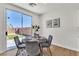 Bright dining area with sliding glass doors to the backyard and a modern table set at 6282 Dollar Bill Ct, Las Vegas, NV 89141