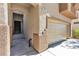 Welcoming home exterior featuring a two-car garage, covered entrance, and attractive architectural details at 6282 Dollar Bill Ct, Las Vegas, NV 89141