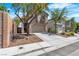 Attractive home with a two-car garage, complemented by low-maintenance landscaping and mature shade trees at 6282 Dollar Bill Ct, Las Vegas, NV 89141