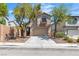 Charming two-story home featuring a tan exterior, well-maintained landscaping, and an attached two-car garage at 6282 Dollar Bill Ct, Las Vegas, NV 89141