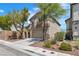 Inviting two-story home with a neutral exterior, mature trees, and a spacious driveway leading to a two-car garage at 6282 Dollar Bill Ct, Las Vegas, NV 89141