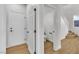 Hallway with a view of a downstairs powder room and a staircase at 6282 Dollar Bill Ct, Las Vegas, NV 89141