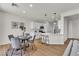 Open kitchen and dining area with white cabinets and stainless steel appliances at 6282 Dollar Bill Ct, Las Vegas, NV 89141