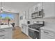 Corner kitchen with a view of the dining area with modern appliances and white cabinets at 6282 Dollar Bill Ct, Las Vegas, NV 89141