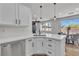 Bright kitchen with an island and bar seating, adjacent to a dining area at 6282 Dollar Bill Ct, Las Vegas, NV 89141