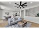 Bright, open-concept living space with modern furnishings flowing into a well-appointed kitchen and staircase at 6282 Dollar Bill Ct, Las Vegas, NV 89141