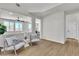 Bright, airy living space with hardwood floors, complemented by modern furnishings and a view of the outdoors at 6282 Dollar Bill Ct, Las Vegas, NV 89141